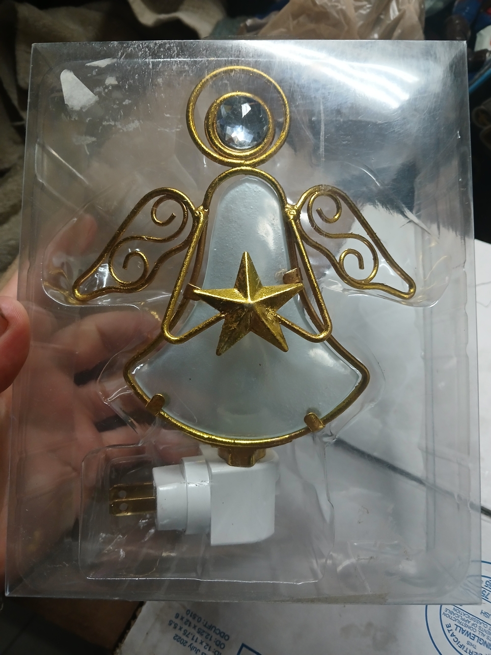 This Kirkland's gold and cream angel night light features a frosted bell-shaped